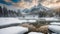 Tranquil scenery with snow castle in clouds. Mountain creek flows from forest hills into glacial lake