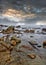 Tranquil seashore with rocks just before a storm, Hainan Island, China