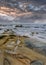 Tranquil seashore with rocks just before a storm, Hainan Island, China