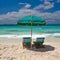 Tranquil seashore, sandy beach, serene clouds, and peaceful waters