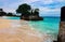 Tranquil shoreline of a sandy beach is seen, with the incoming waves