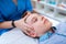 Tranquil short-haired boy calmly lying during relaxing head massage