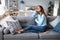 Tranquil smiling millennial woman leaning on sofa