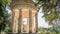 Tranquil stone gazebo surrounded by tall trees in Paris, France