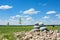 Tranquil stone stacks in a serene scene against lush green grass and clear blue sky