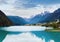 Tranquil summer Italian dolomites mountain lake and village view (Auronzo di Cadore