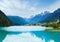 Tranquil summer Italian dolomites mountain lake and village view (Auronzo di Cadore