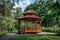 Tranquil summer park setting with a charming wooden gazebo for peaceful relaxation