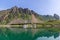 A tranquil summer scene in the Lofoten Islands, where sailboats and traditional Rorbu cabins are mirrored in the still water