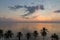 Tranquil sunrise in Hua Hin beach with coconut trees, Thailand