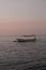 Tranquil Sunset Beach Scene with Boat on the Water. North Bali Indonesia.