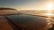 Tranquil sunset over water, coastline and sand, nature beauty generated by AI