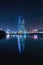 Tranquil urban landscape featuring a canal lit up by the night sky: the Bahrain World Trade Center