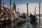 Tranquil Venice Gondolas Docked at Serene Pier with Murky Water - Peaceful Italian Scene