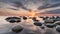 Tranquil view of sunset with stones the water. On shore of the Baltic Sea in Estonia.