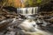 tranquil waterfall in Pennsylvania forest during autumn