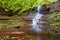 Tranquil waterfall scenery in the middle of green forest. Cascade of waterfalls near the village. Rusilov, Ukraine, Europe.