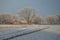 Tranquil winter scene of a pastoral field blanketed in layer of frosty snow, in Westphalia, Germany