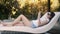 Tranquil woman uses smartphone lying on couch at resort