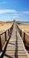 Tranquil Wooden Bridge Over Sand Beach: A Reverent French Landscape