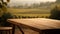 Tranquil wooden table offers a blank canvas for product presentation, with a blurred vineyard view