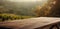 Tranquil wooden table offers a blank canvas for product presentation, with a blurred vineyard view