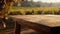 Tranquil wooden table offers a blank canvas for product presentation, with a blurred vineyard view