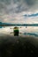 Tranquility Scene of Old fishermans boat in a lake waters with r