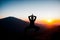 Transcendent Heights: Silhouette of Woman Practicing Yoga atop a Mountain. Ai generated.