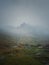 Transfagarasan mountain peak seen through the dense fog. Rainy scene in the mounts, hiking in the mist