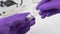 Transfer of coronavirus vaccine in a glass capsule. Hand in hand in medical protective gloves