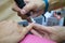 Transgender woman in the beauty salon and she is getting a manicure by the professional nail stylist. Beauty and health center.