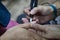 Transgender woman in the beauty salon and she is getting a manicure by the professional nail stylist. Beauty and health center.