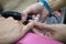 Transgender woman in the beauty salon and she is getting a manicure by the professional nail stylist. Beauty and health center.