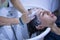 Transgender woman shampooing her hair for a keratin treatment at a hair salon. Transgender concept, hairdresser, beauty