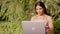 Transgender woman working with laptop outdoors