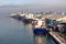 Transhipment terminal for discharging cement cargo by shore cranes. A view of berths with cargo ships and the water area of the po