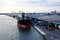 Transhipment terminal for discharging cement cargo by shore cranes. A view of berths with cargo ships and the water area of the po