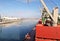 Transhipment terminal for unloading bulk cargo of chemical sulfur from ships using a coastal crane. Port of Zorf-Lasfar, Morocco.