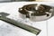 The transition flange after processing lies on the technical drawing. Next to the part is the measuring tool, a caliper