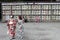 Translation: girls in kimono in front of drums or barrels of sake (Japanese alcoholic drinks) at Tsurugaoka shrine