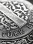 Translation: Turkish lira. Fragment of 1 lira coin close-up. National currency of Turkey. Black and white vertical illustration