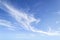 Translucent airy cirrus clouds high in a blue sky. Cloud species and varieties. Atmospheric phenomena. Skyscape on a sunny day