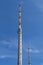 Transmission towers for the transmission of television, radio and mobile in front of a bright blue sky