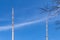 Transmission towers for the transmission of television, radio and mobile in front of a bright blue sky