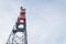 Transmitters and aerials on telecommunication tower, sunset in snowy country