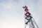 Transmitters and aerials on telecommunication tower, sunset in snowy country