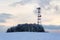 Transmitters and aerials on telecommunication tower, sunset in snowy country