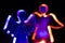 Transparent angel shaped figures illuminated by colorful bulbs isolated on black background