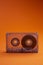 Transparent audio cassette tape orange background. Front, view